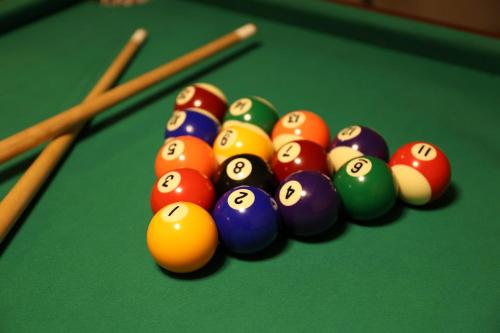 a group of billiard balls and cues on a pool table at Unite in Myoko in Taguchi