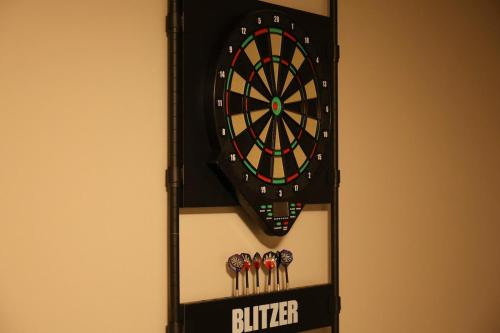 a dart board hanging on a wall with darts at Unite in Myoko in Taguchi