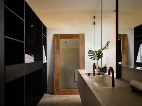 a bathroom with a sink and a mirror at Esh Hotel & Spa, a Member of Design Hotels in Nosara