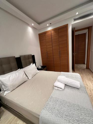 a bedroom with a large bed with two towels on it at View green garden ligue arabe in Casablanca