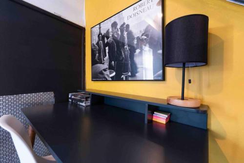 a black table with a lamp and a picture on the wall at 1918 Duplex with Character City Center in Philadelphia
