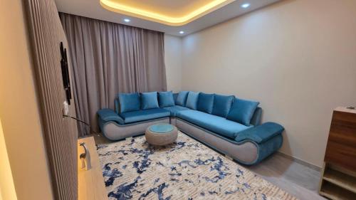 ein blaues Sofa, das in einem Wohnzimmer steht in der Unterkunft Evrest in New cairo