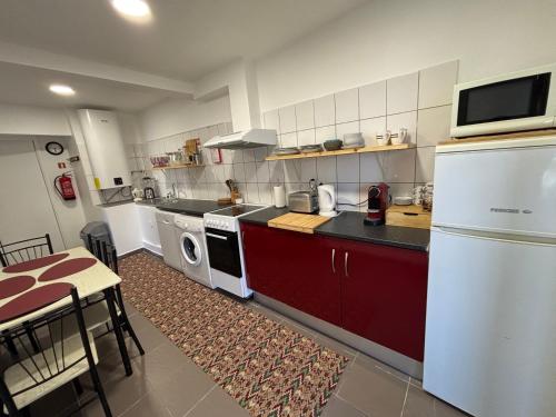 a kitchen with a white refrigerator and a microwave at Granny House Madeira in Funchal