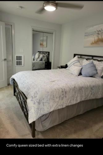 a bedroom with a king sized bed with extra linen changes at Downtown and Inner Harbor Apartment in Baltimore