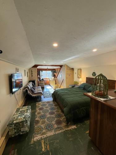 a bedroom with a bed and a living room at Natalie House in Boston