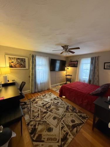 a bedroom with a red bed and a rug at Natalie House in Boston
