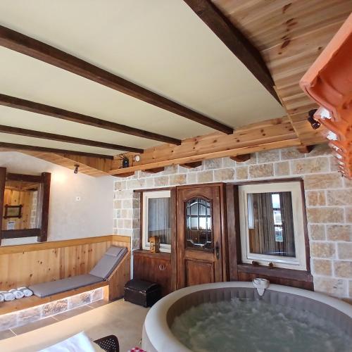a large bathroom with a tub in a room at Vila Merak in Gusinje