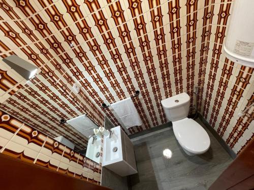a bathroom with a toilet and a shower curtain at CasaMaria in Vila do Conde