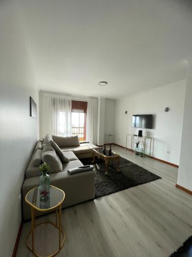 a living room with a couch and a table at CasaMaria in Vila do Conde