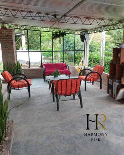 a group of chairs and a table on a patio at Harmony Risk in Albán