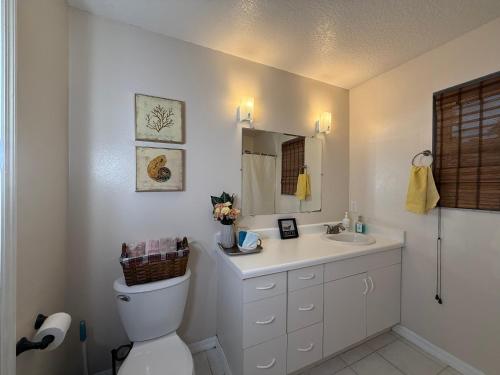 a bathroom with a toilet and a sink at Suit with Kitchen & Bath in Cocoa