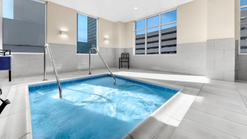 a large swimming pool with blue water in a building at Hyatt Place Colorado Springs Downtown in Colorado Springs