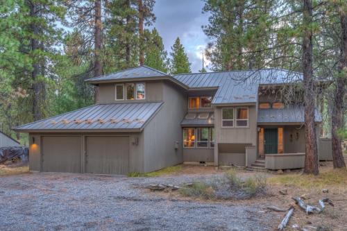 a house in the woods with a garage at Rock Ridge 009 in Black Butte Ranch
