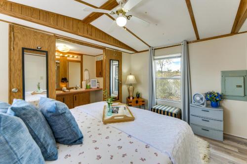 a bedroom with a large bed with blue pillows at Lakefront w/ Dock, Detached Studio, Fire Pit! in Georgetown