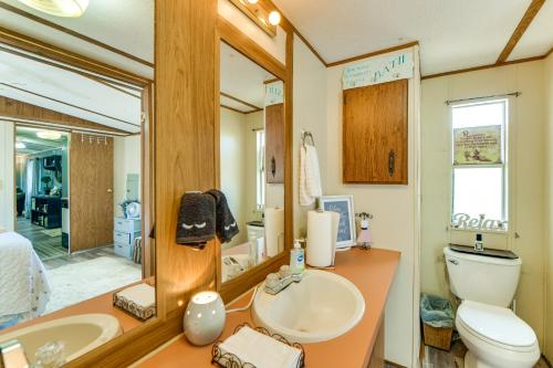 a bathroom with a sink and a toilet and a mirror at Lakefront w/ Dock, Detached Studio, Fire Pit! in Georgetown