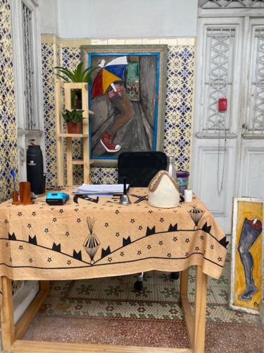 a table in a room with a painting on the wall at Borba Beach House in Recife