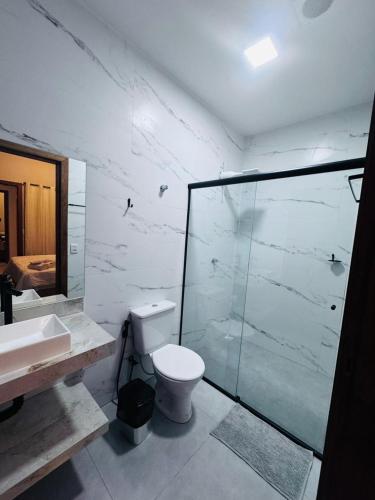 a bathroom with a toilet and a glass shower at Hotel Luxx in Sinop