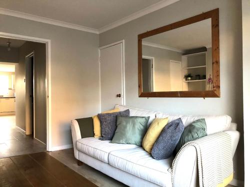a white couch with colorful pillows in a living room at Moat View Donaghadee in Donaghadee