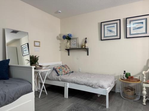 a room with a bed and a table and a mirror at Suit with Kitchen & Bath in Cocoa