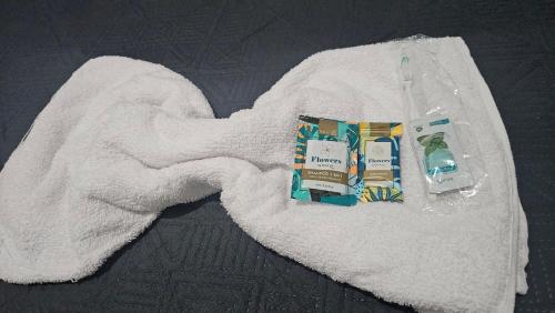 a white towel with a package of products on it at Casa Vigia 2 Quartos in Vigia