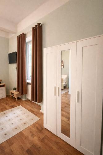 a room with white cabinets and a bedroom at Halbinsel am See in Blieskastel