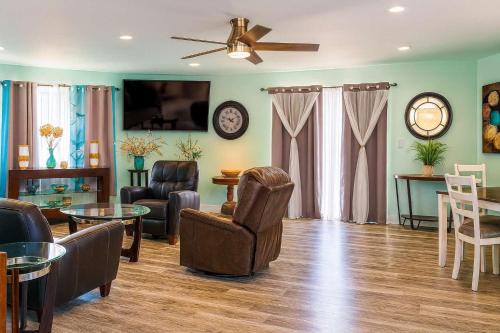 a living room with furniture and a ceiling fan at Blizzard's Lighthouse home in Port Isabel