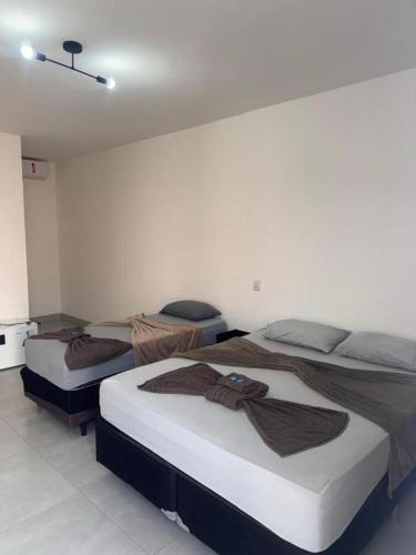 two twin beds in a room with at Hotel Luxx in Sinop