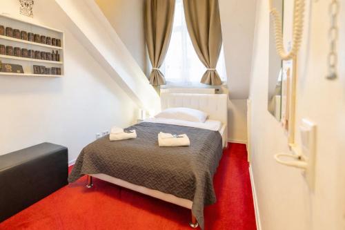 a bedroom with a bed with two towels on it at DATRI Petite Suite 4 in Vienna