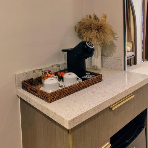 a kitchen counter with a tray with a coffee maker at Dahican Beach Resort and Spa in Sampong