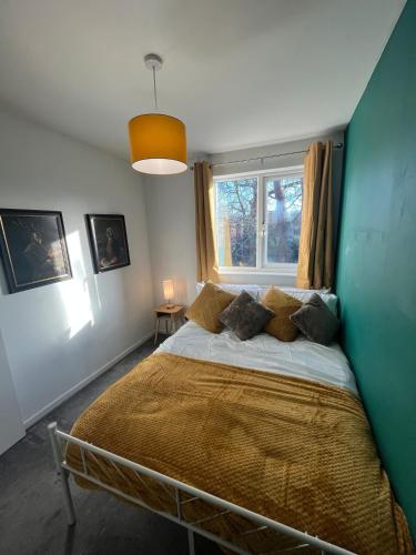 a bedroom with a bed in a room with a window at Cosy Home Contractors, Relocations, Coffee Machine in Beoley