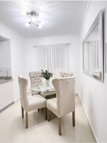a dining room with a glass table and two chairs at EL ricon del paseo in Mendoza