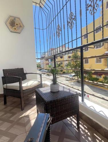 a balcony with a table and chairs and a large window at EL ricon del paseo in Mendoza