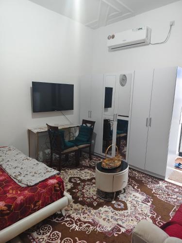 a living room with a couch and a tv at studio in Abu Dhabi
