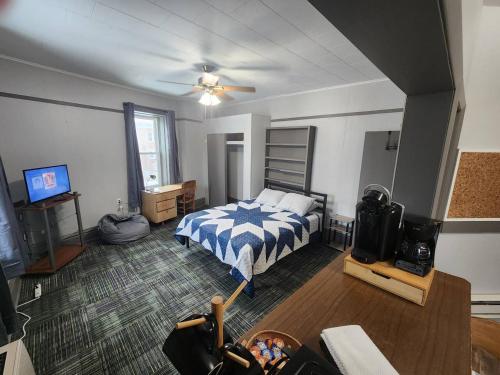 a bedroom with a bed and a tv in it at K5 2nd Floor Studio Near MTU, Keweenaw, Great Rates