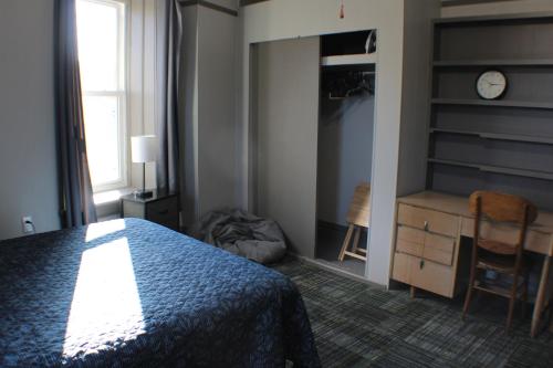 a bedroom with a bed and a desk and a chair at K5 2nd Floor Studio Near MTU, Keweenaw, Great Rates