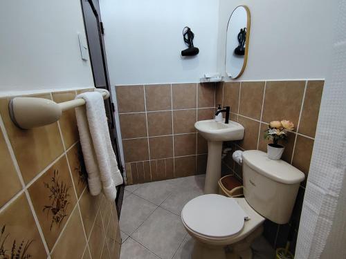 a bathroom with a toilet and a sink at Galápagos Islands-Apartment in Santa Cruz in Puerto Ayora