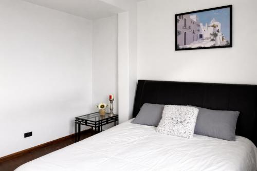 a bedroom with a black and white bed and a table at Location! Location! 2bd 1bth spacious apartment! in Chicago