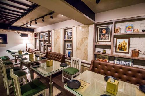 a restaurant with tables and chairs and booths at Hotel Oriental Aster - Mumbai International Airport in Mumbai