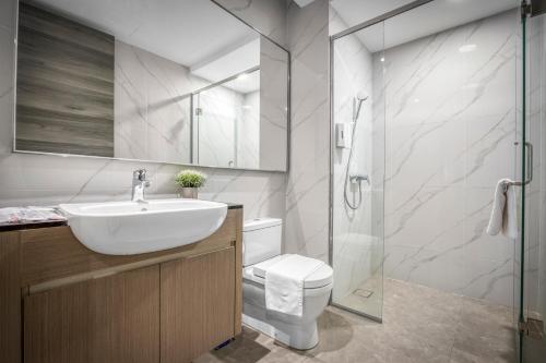 a bathroom with a sink and a toilet and a shower at Cavera Bukit Bintang in Kuala Lumpur