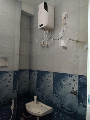 a bathroom with a sink and a toilet in it at Shanmikha Residency - Attur - Near Highways in Āttūr