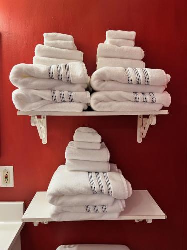 a stack of towels on a shelf in a bathroom at Alaska Tucked Inn in Fairbanks