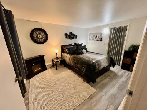 a bedroom with a bed and a clock on the wall at Alaska Tucked Inn in Fairbanks