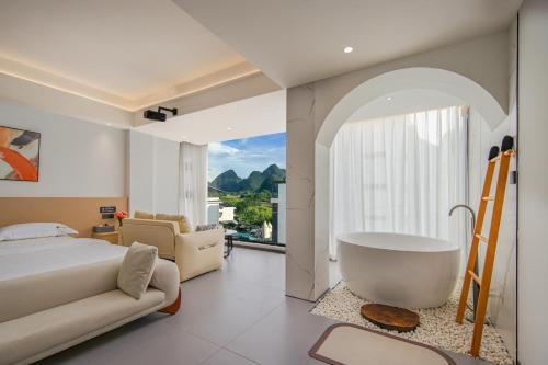 a bedroom with a large bed and a bath tub at Jiheshan residential accommodation Yulong River Yangshuo in Yangshuo
