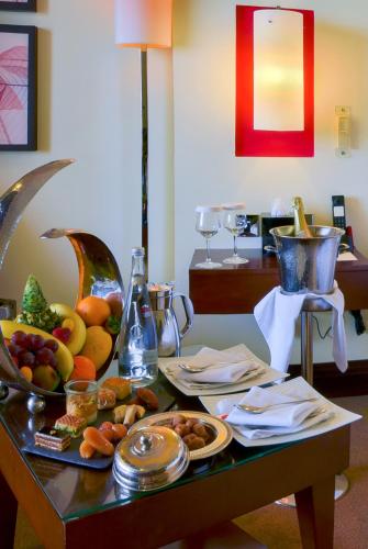 a table with a tray of fruit on it at Sofitel Al Khobar The Corniche in Al Khobar