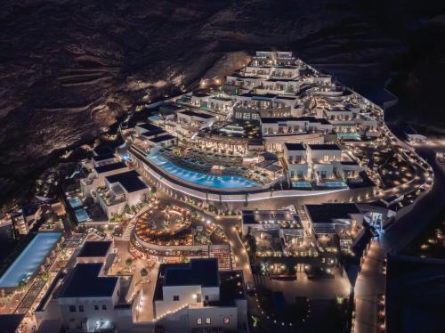 an aerial view of a resort complex at night at Sandblu Santorini, LXR Hotels & Resorts in Kamari