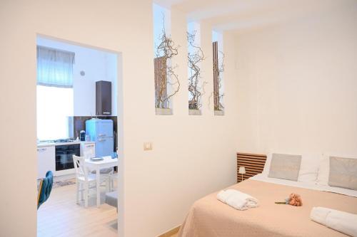 a bedroom with a bed and a dining room at Nonna Tetta Cozy House by Gessica Holiday in Monopoli