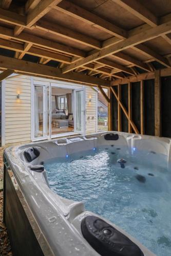 a large jacuzzi tub in a house at Cosy Studio Cabin with Optional Hot Tub Lilliput near Sandbanks beach in Poole
