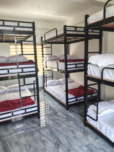 a room with four bunk beds in a dorm at Poozhikuth Homestay in Sultan Bathery