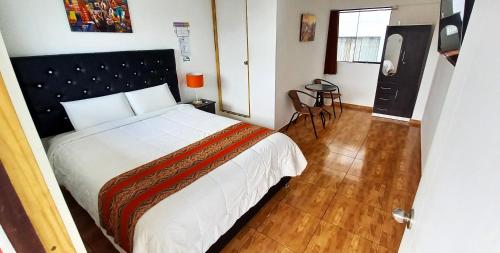 a bedroom with a large bed and a television at Hostal Cusco de mis Sueños in Cusco