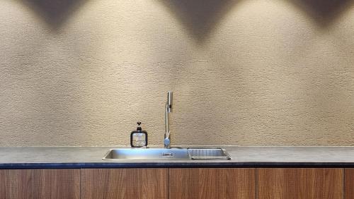 a kitchen sink with a faucet on a counter at Myeongwolga Poolvilla in Busan